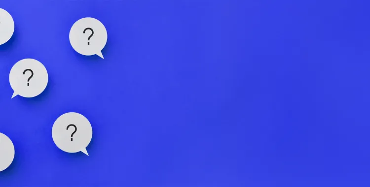 A hand pointing at a speech bubble with a light bulb icon among other bubbles with question marks on a blue background.