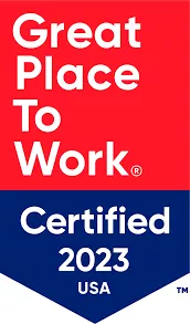 Logo with red and blue sections. The red top section reads 'Great Place To Work' in white text. The blue bottom section reads 'Certified 2023 USA' in white text.